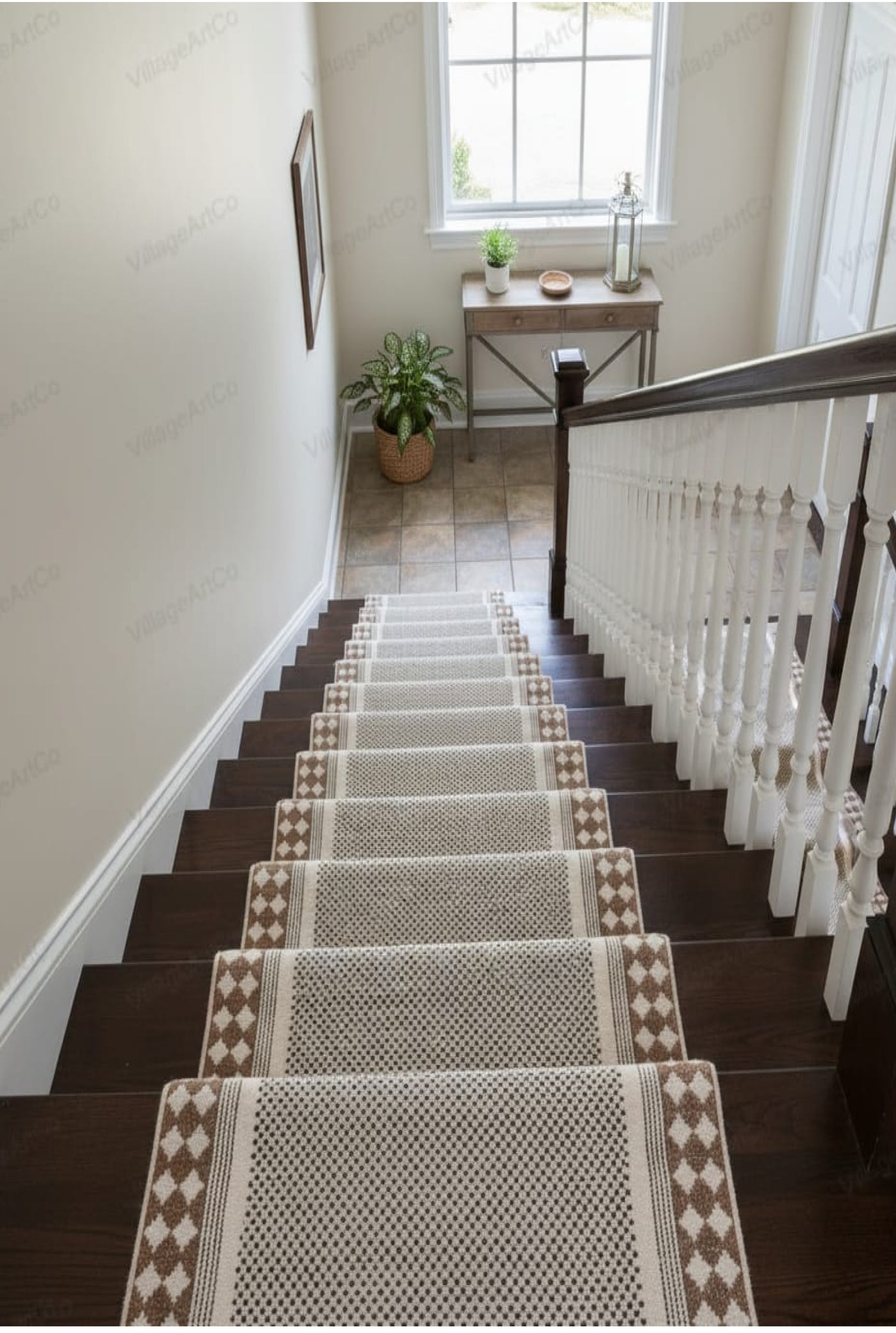 A set of cream and brown woven stair runner rugs with diamond-patterned borders, styled on a dark wood staircase in a bright, modern home interior.