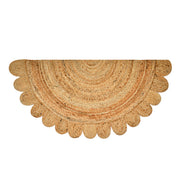 A semi-circular braided jute rug in natural tan and light brown tones, featuring a scalloped edge, shown against a plain white background.